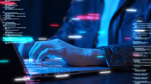person working on laptop in dark
